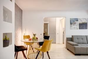 a living room with a couch and a table and chairs at Elegant Old Town Escape in Bucharest