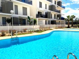 a swimming pool in front of a building at Denia Apartment Rental - Vivir La Vida in Denia