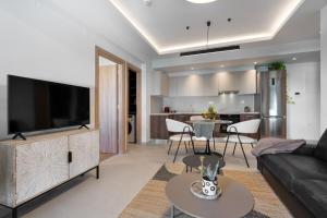 a living room with a large flat screen tv at Comfy Apt terrace and parking 800m to old town and beach in Chania Town