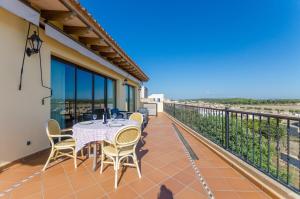 a patio with a table and chairs on a balcony at Can Nadal - Adults Only in Sineu