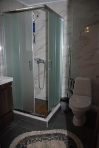 a bathroom with a glass shower with a toilet at Panos House - Warm and cozy retreat in Tríkala +63 photos