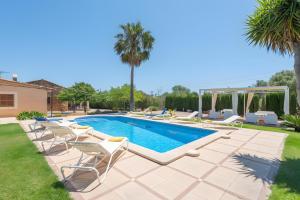 a swimming pool with lounge chairs and a swimming poolvisor at Finca Cati Ref 57 in Son Servera