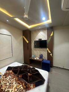 a room with a bed and a projection screen at HOTEL PREMIER CHOICE - JUST 50 Meters FROM AJMER SHARIF DARGAH in Ajmer