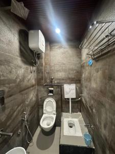 a small bathroom with a toilet and a sink at HOTEL PREMIER CHOICE - JUST 50 Meters FROM AJMER SHARIF DARGAH in Ajmer