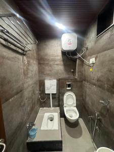 a small bathroom with a toilet and a sink at HOTEL PREMIER CHOICE - JUST 50 Meters FROM AJMER SHARIF DARGAH in Ajmer
