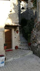 a stone building with a door and some stairs at Casa Vittoria in Artena