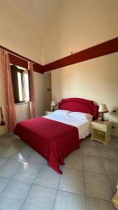 a bedroom with a large bed with a red blanket at Casa Santicelli - Room in Maratea