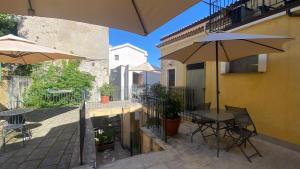a patio with a table and an umbrella at Casa Santicelli - Room in Maratea