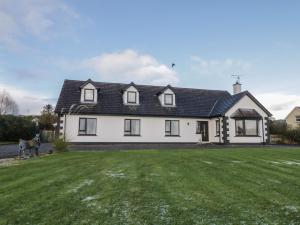 a white house with a black roof at St Michael's in Muff