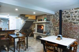 a kitchen and dining room with a stone fireplace at El Rincón del Tarabilla in Fermoselle