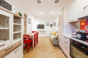 a kitchen and living room with a table and a couch at Varese Centro - Eleganza con comfort e stile in Varese