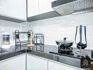 a kitchen with a counter top with a bowl on the stove at Pool,TVBox,Landed,5 min Aeon,Bukit Indah,Legoland in Johor Bahru