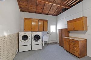 a laundry room with a washer and dryer in it at RoomL in Hayward