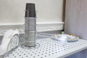 a table with a plate and a stack of plates on it at Casa Baccanico - a due passi da autostazione in Avellino