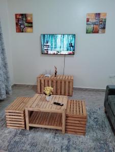 a wooden coffee table in a living room at Royal Stay in Kira