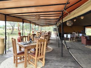 a tent with tables and chairs on a patio at Africa Safari Serengeti Kusini in Serengeti National Park