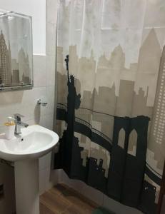 a bathroom with a sink and a shower curtain at Spacious 3-bedroom and 2 bathroom home with private pool and patio and free Wi-Fi in Calango