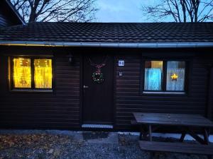 a house with a christmas ornament on the door at Chalet 94 la boverie in Rendeux
