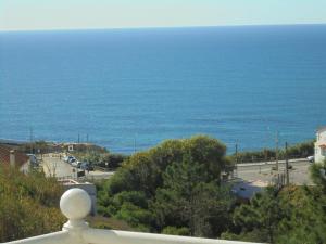 a view of the ocean from a balcony at Ericeira Sunset Apartment in Ericeira