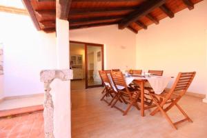 a dining room with a table and chairs at ISA - Villas with private pool in Costa Rei just 500 meters from the sea in Costa Rei