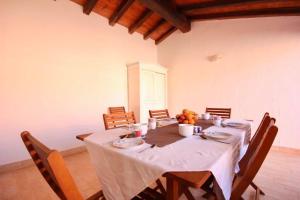 a dining room with a long table with chairs at ISA - Villas with private pool in Costa Rei just 500 meters from the sea in Costa Rei