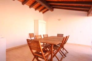a wooden table and chairs in a room at ISA - Villas with private pool in Costa Rei just 500 meters from the sea in Costa Rei +28 photos