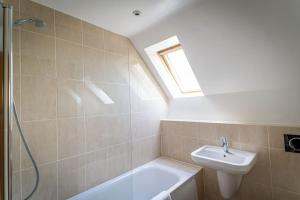 a bathroom with a sink and a toilet and a shower at Weaver, woodland lodge with hot tub for 12 in Oakamoor +38 photos