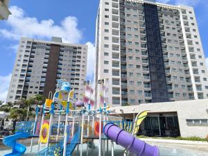 a playground in front of a large building at Salinas Exclusive Resort in Salinópolis