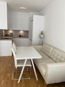 a living room with a white couch and a table at Quiet apartment near Prague centre in Prague