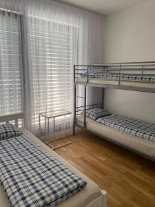 two bunk beds in a room with a window at Quiet apartment near Prague centre in Prague