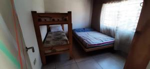a small room with two bunk beds and a window at DiversidadMDP in Mar del Plata