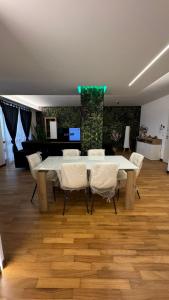 a dining room with a table and white chairs at 085 luxury apartment in Montesilvano