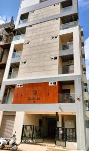 an apartment building with a brown door at 3 Home Tales (Brookefield) in Bengaluru