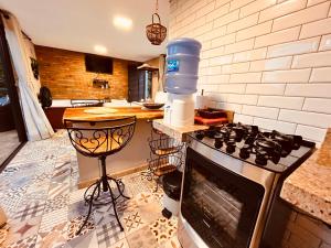a kitchen with a stove with a water bottle on it at NATIVOS DE MINAS in Santana do Riacho