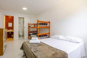a bedroom with a bed and a bunk bed at Apto 1 quarto no Golden Lake! in Arraial do Cabo +40 photos