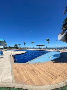 a large swimming pool with a person in the water at Apto 1 quarto no Golden Lake! in Arraial do Cabo