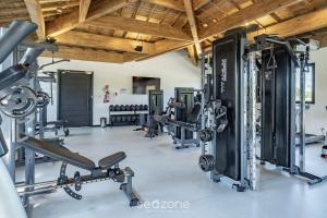 a fitness gym with several treadmills and machines at VLP - Apartamentos próximos à Praia do Forte/BA in Mata de Sao Joao