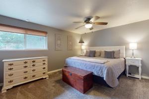 a bedroom with a bed and a ceiling fan at Lavender Hollow in Bend