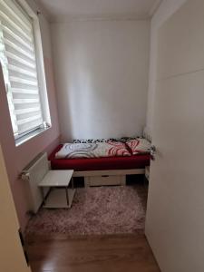 a small bedroom with a bed and a window at Apartment Armando in Liezen