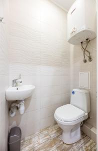a bathroom with a toilet and a sink at Апартаменти Дарницька площа in Kyiv