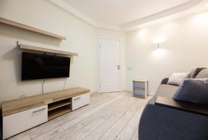 a living room with a flat screen tv on a wall at Апартаменти Дарницька площа in Kyiv