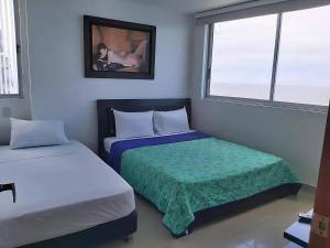 En eller flere senge i et værelse på Lodging Apartamento 31 Frente a la Playa