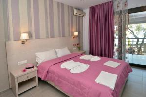 Postel nebo postele na pokoji v ubytování Hotel Akti