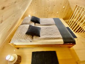 a bedroom with a bed in a wooden room at Sweet Bee Cottage in Bovec