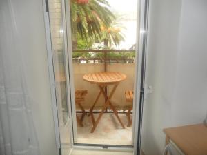 a glass door leading into a balcony with a table at Guest House Leon in Korčula