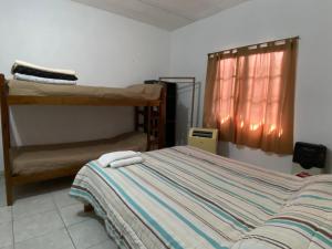 a bedroom with a bed and bunk beds in it at Casa May - A 15 min del Aeropuerto in Barrio Esteban Echeverría