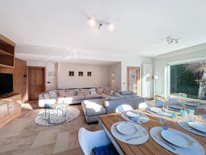 a living room with a couch and a table with plates on it at Villa Zonnedauw - Koksijde in Koksijde