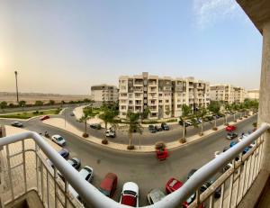 a view from a balcony of a parking lot with buildings at Home for you with free WiFi in Madinaty in Madinaty