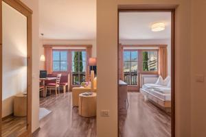 a room with a bed and a living room at Appartements Riegelehof in Laion