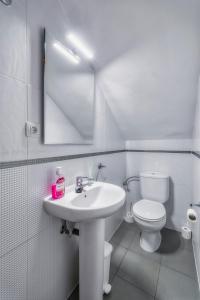 a white bathroom with a sink and a toilet at Beach Blessing in Isla Plana +14 photos